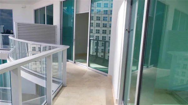 a view of staircase with railing and white walls