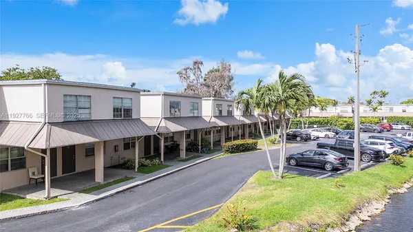 a view of a house with backyard porch and sitting area