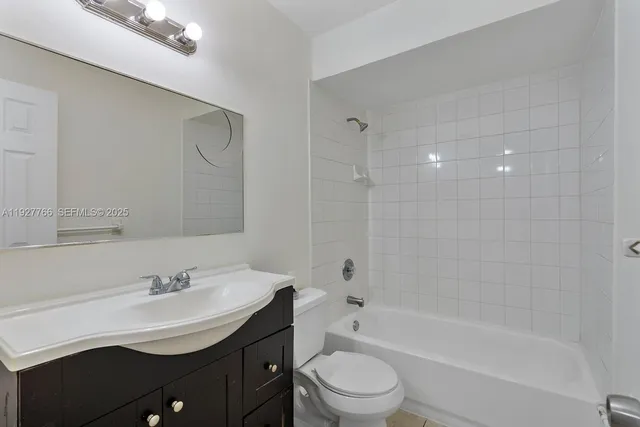a view of kitchen with refrigerator cabinets and stove top oven