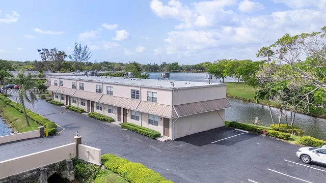 an aerial view of a house with a yard and potted plants