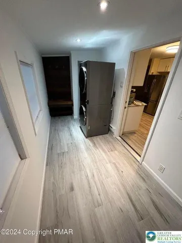 a view of a hallway with wooden floor