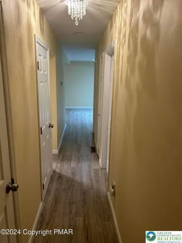 a view of a room with wooden floor