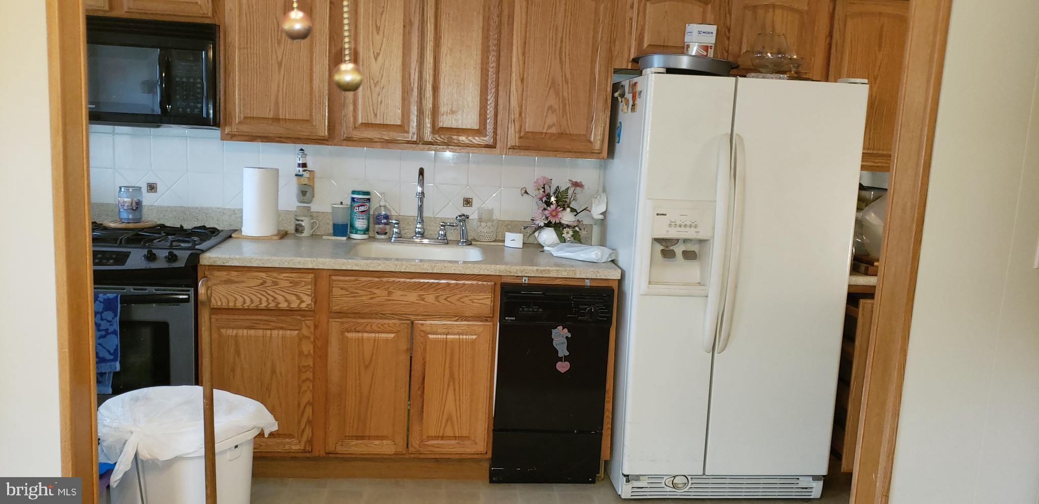 7818 New Battle Grove Road Baltimore, MD 21222 - Photo 11 of 13 a kitchen with stainless steel appliances a refrigerator sink and cabinets