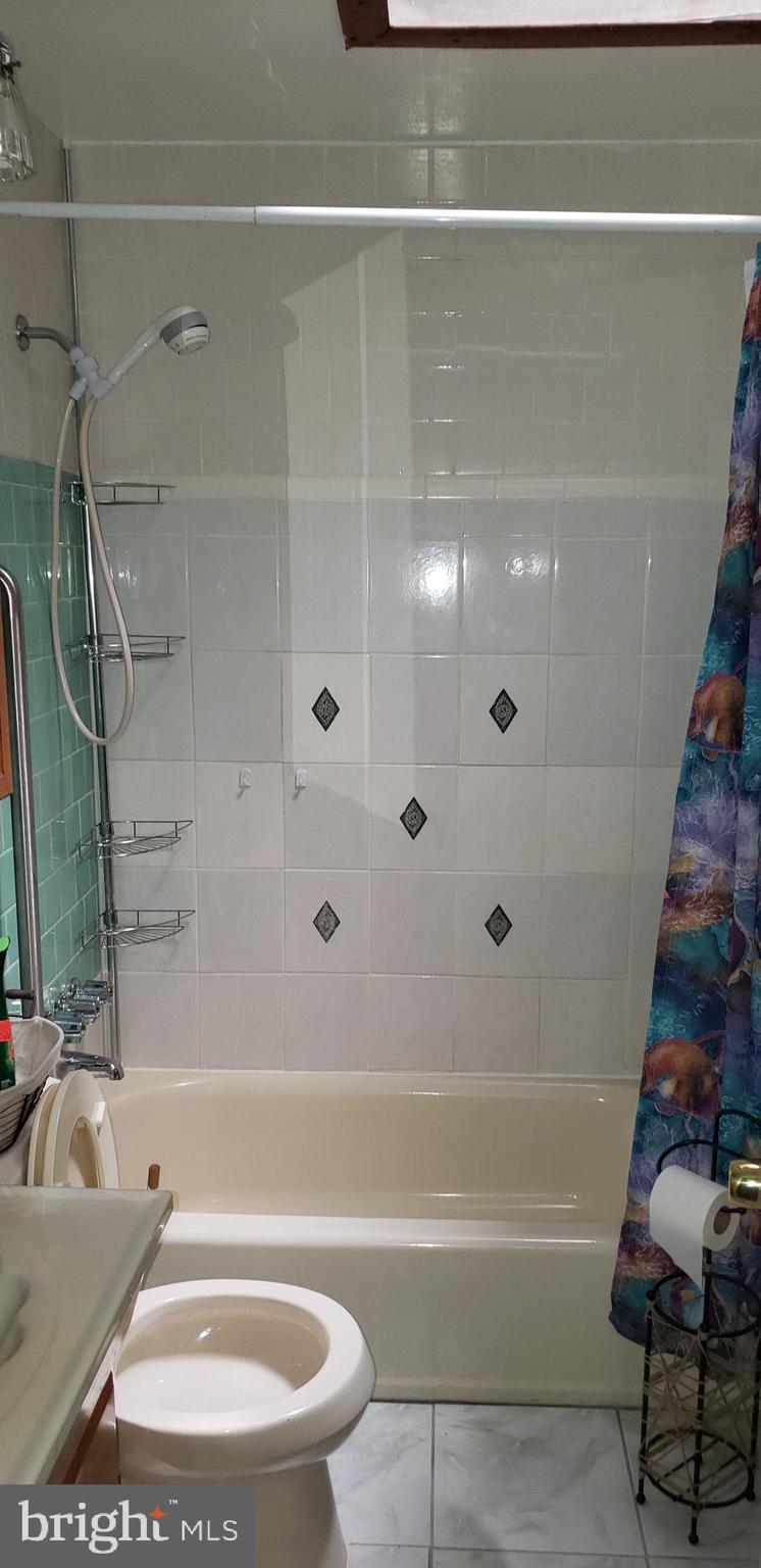 7818 New Battle Grove Road Baltimore, MD 21222 - Photo 13 of 13 a bathroom with a bathtub and a shower