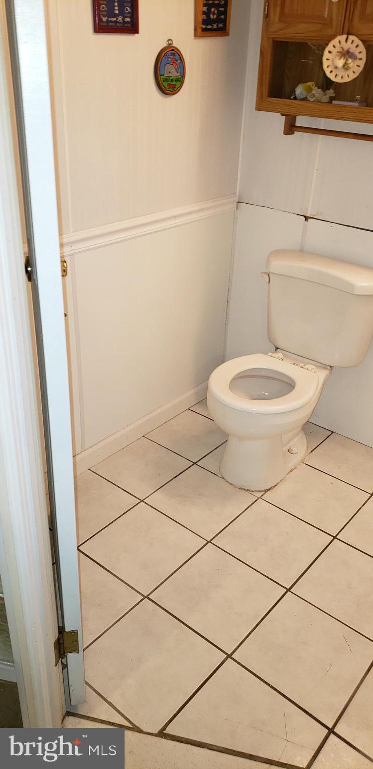 7818 New Battle Grove Road Baltimore, MD 21222 - Photo 8 of 13 a bathroom with a toilet and a shower