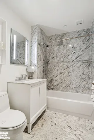 a bathroom with a toilet sink and shower