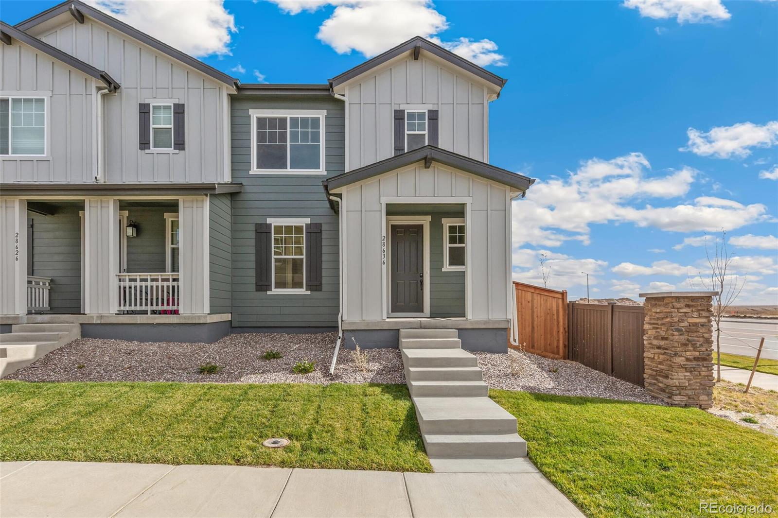 28636 East 6th Place Watkins, CO 80137 - Photo 1 of 32 a front view of a house with garden