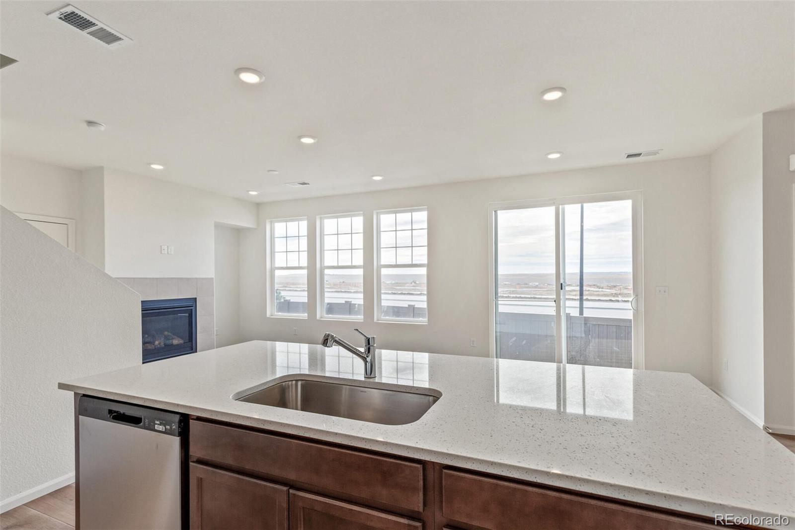 28636 East 6th Place Watkins, CO 80137 - Photo 15 of 32 a kitchen with a sink and large window