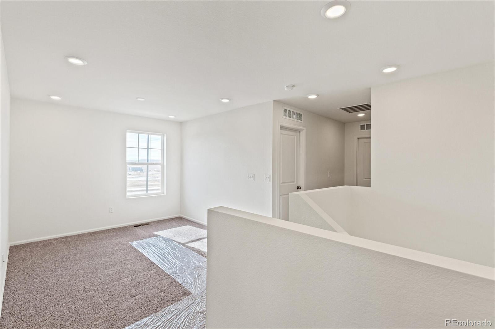 28636 East 6th Place Watkins, CO 80137 - Photo 18 of 32 a view of an empty room with a window