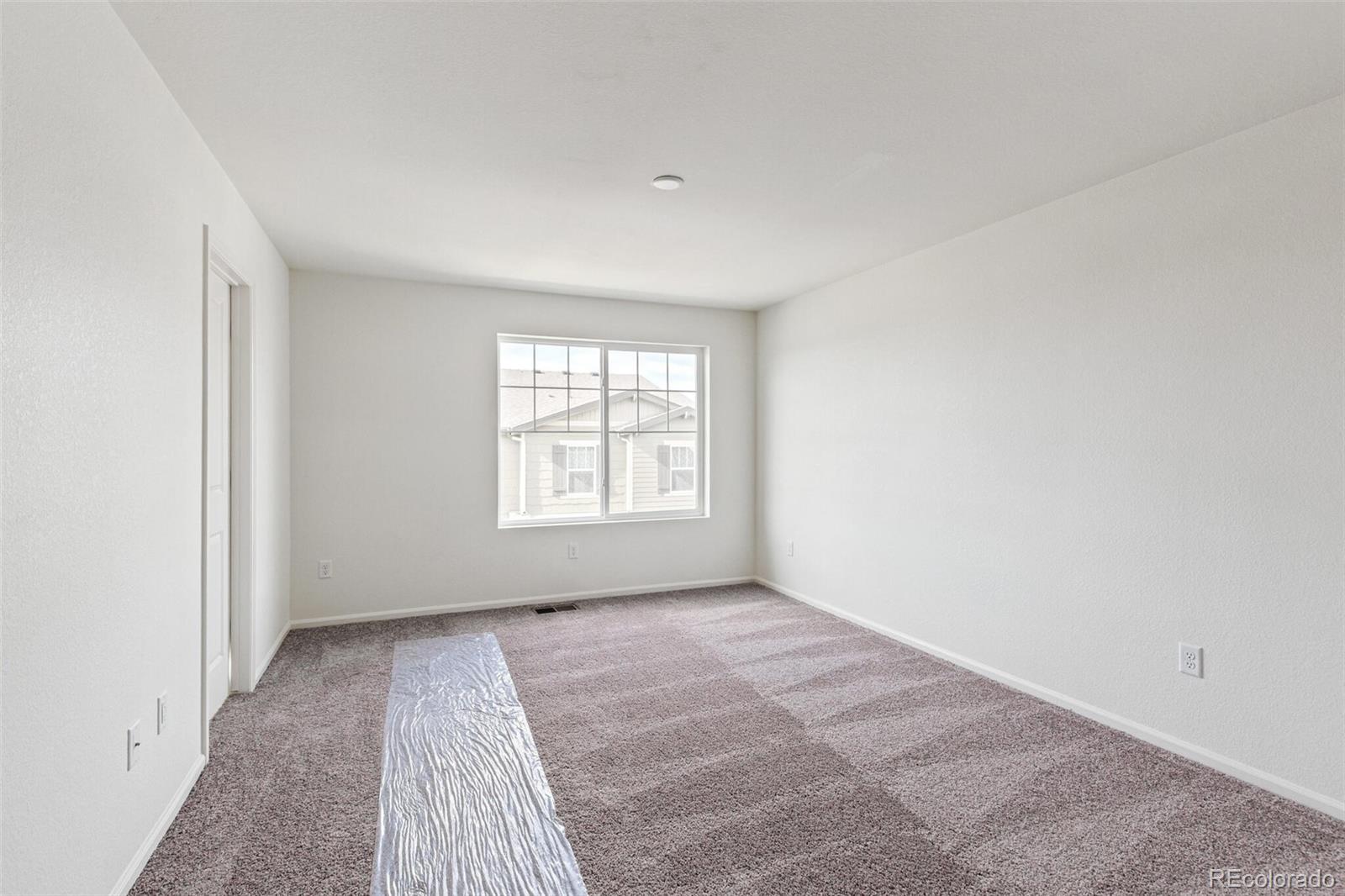 28636 East 6th Place Watkins, CO 80137 - Photo 19 of 32 an empty room with a window