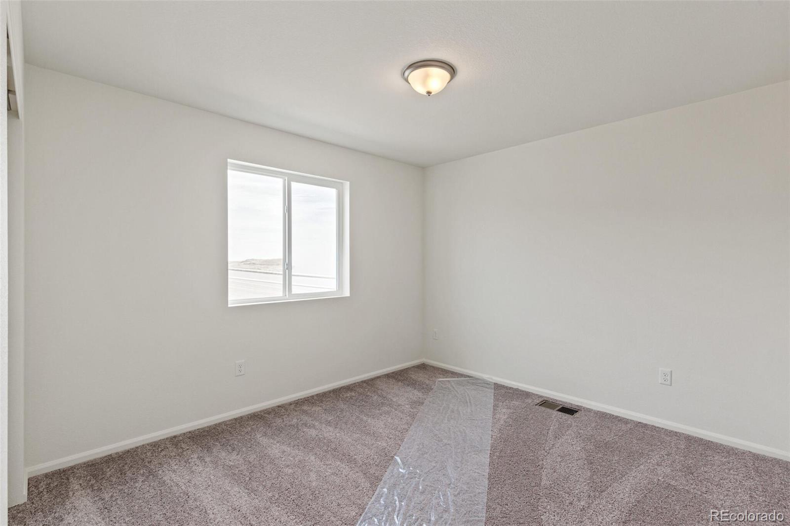 28636 East 6th Place Watkins, CO 80137 - Photo 24 of 32 an empty room with a window