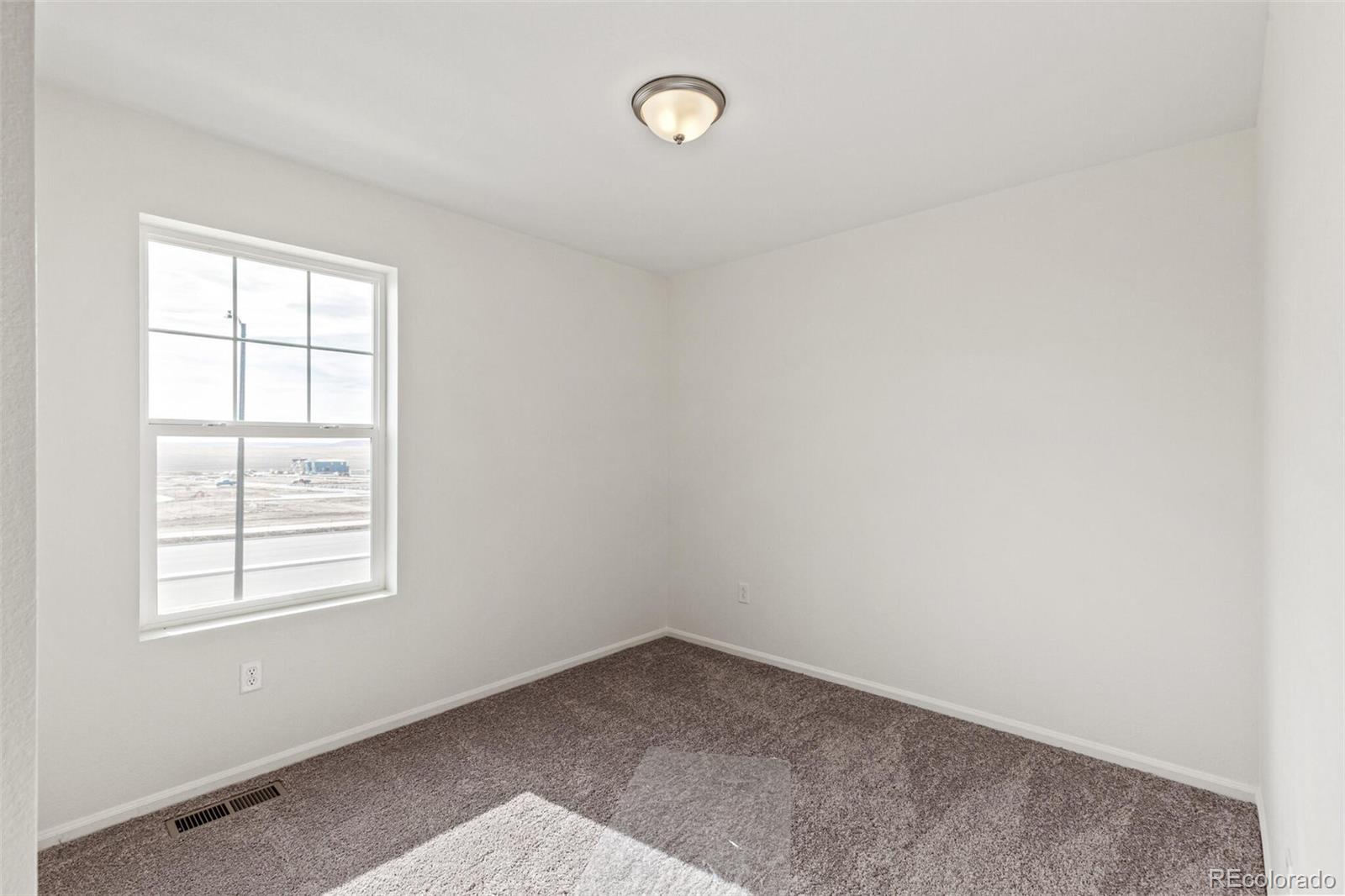 28636 East 6th Place Watkins, CO 80137 - Photo 26 of 32 an empty room with a window