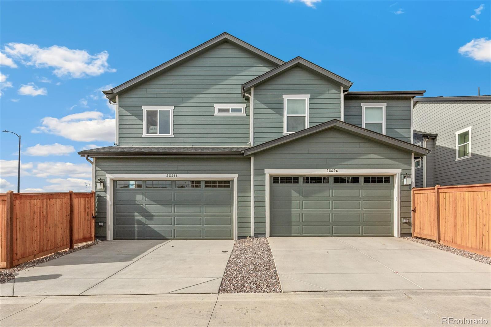 28636 East 6th Place Watkins, CO 80137 - Photo 29 of 32 a front view of a house with a garage and a garage