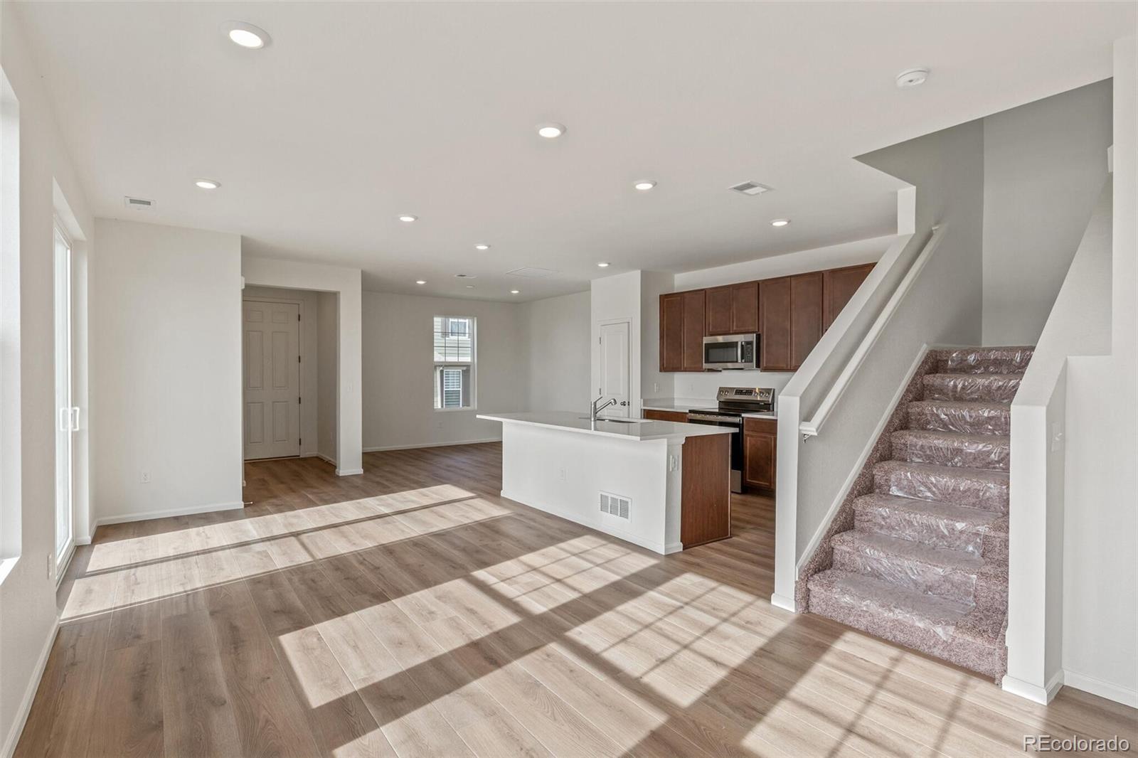 28636 East 6th Place Watkins, CO 80137 - Photo 3 of 32 a view of a kitchen with stairs and a window