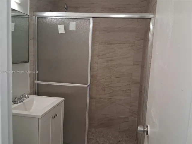 a bathroom with a sink and shower