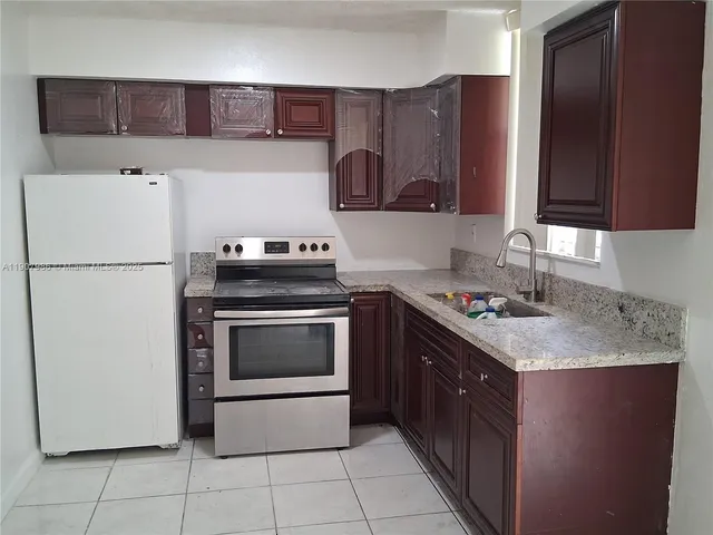 a kitchen with a stove top oven and cabinets