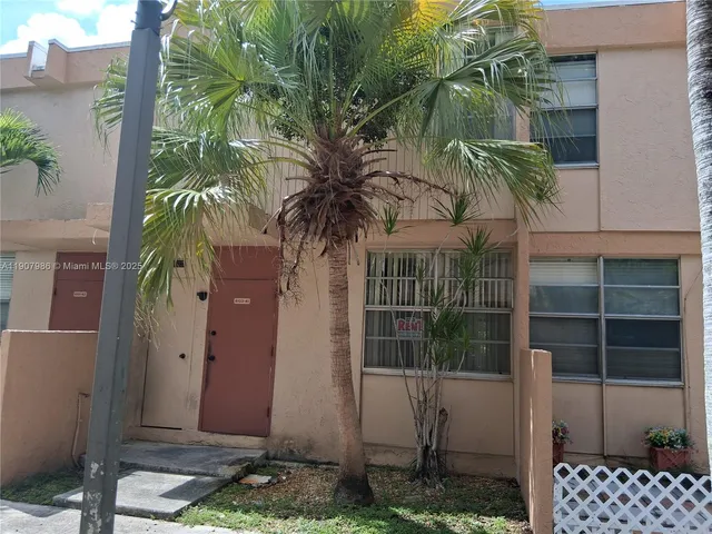 a view of a house with a tree