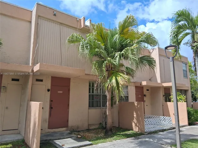 a couple of palm trees in front of door