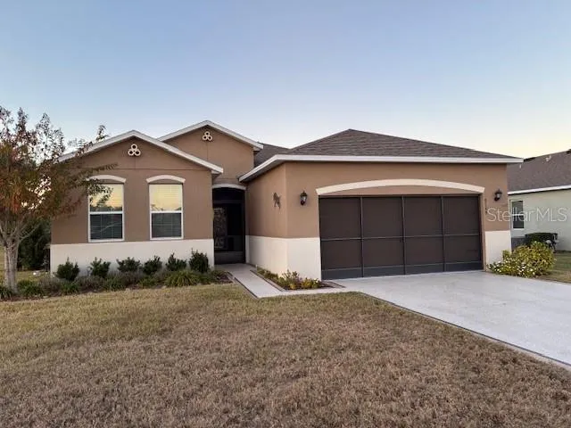 a front view of a house with a yard and garage