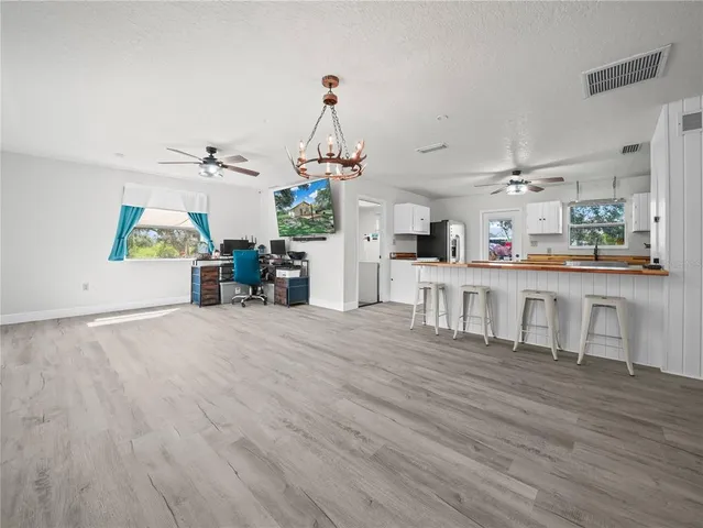 a kitchen with stainless steel appliances kitchen island wooden floors and center island