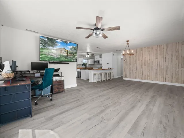a view of a workspace with furniture and wooden floor