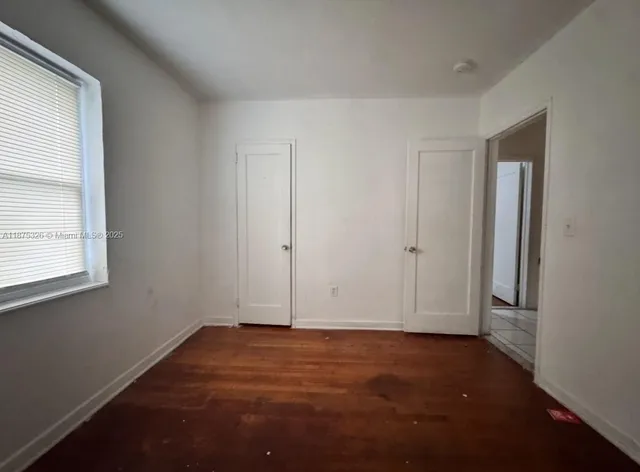 an empty room with a empty space and windows