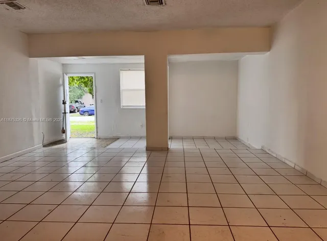 a kitchen with granite countertop a sink and a refrigerator