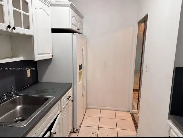 a bathroom with a granite countertop toilet a sink and a shower