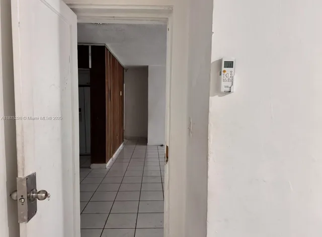 a view of a backyard with plants and a bench