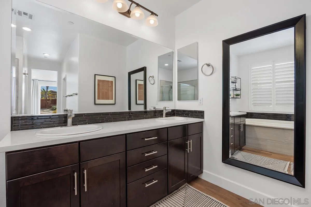 3741 Bergen Peak Place Carlsbad, CA 92010 - Photo 17 of 39 a bathroom with double vanity and a mirror