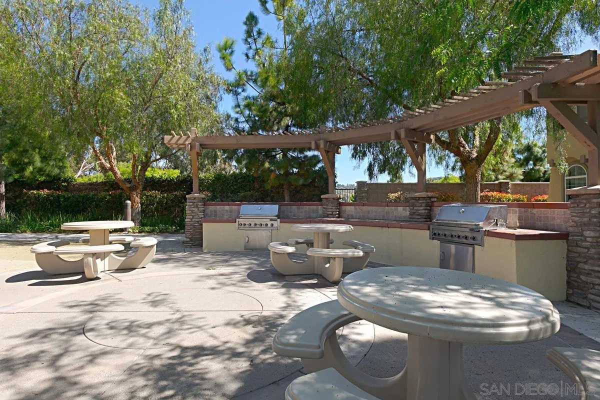 3741 Bergen Peak Place Carlsbad, CA 92010 - Photo 30 of 39 a backyard of a house with barbeque oven table and chairs