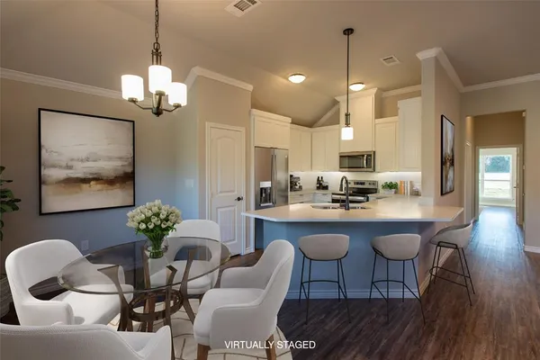 a dining room with furniture a chandelier and wooden floor