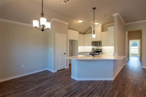 a view of kitchen and sink with wooden floor