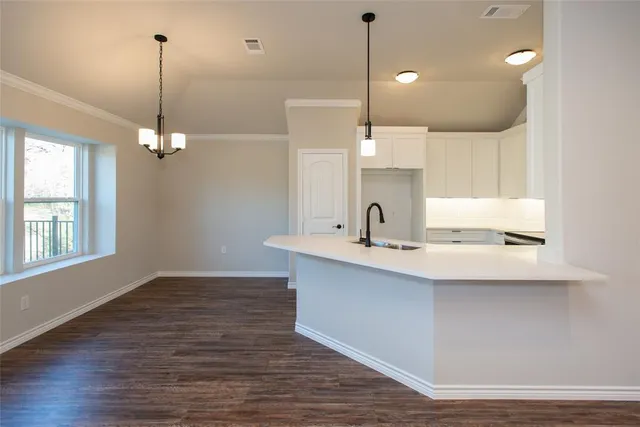 a kitchen with kitchen island a sink appliances and a counter top space