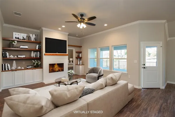 a living room with furniture a fireplace and a flat screen tv