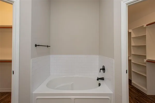 a view of walk in closet with empty racks