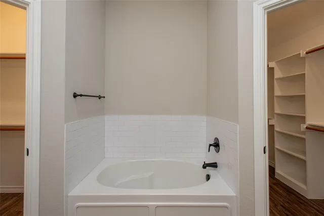 a view of walk in closet with empty racks