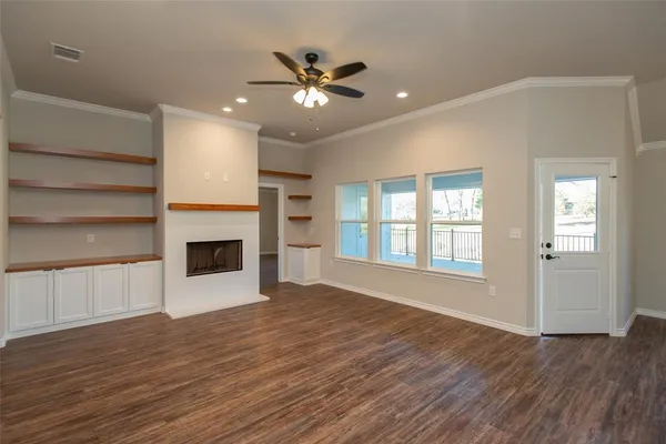 a view of an empty room with a fireplace and a window