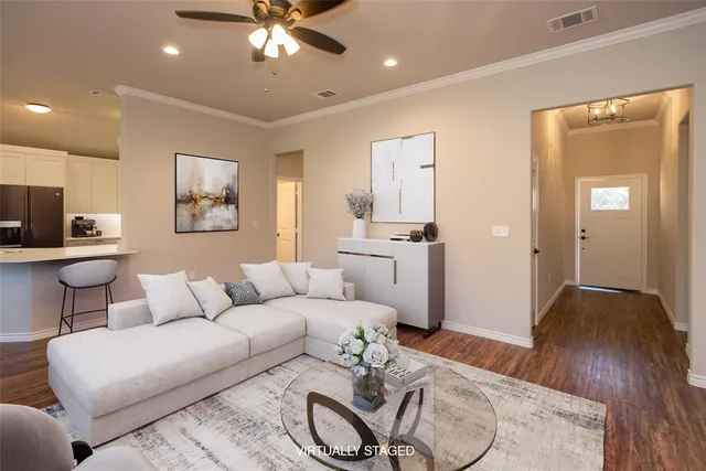 a living room with furniture and a chandelier