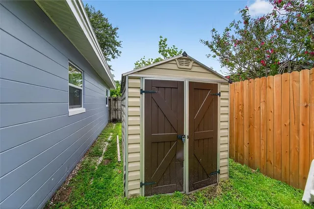 an aerial view of a house with a garden and lake view