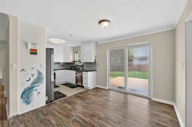 a kitchen with stainless steel appliances kitchen island granite countertop a stove a sink and a microwave