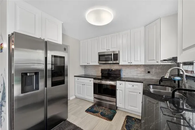 a view of a kitchen with a sink cabinets and wooden floor