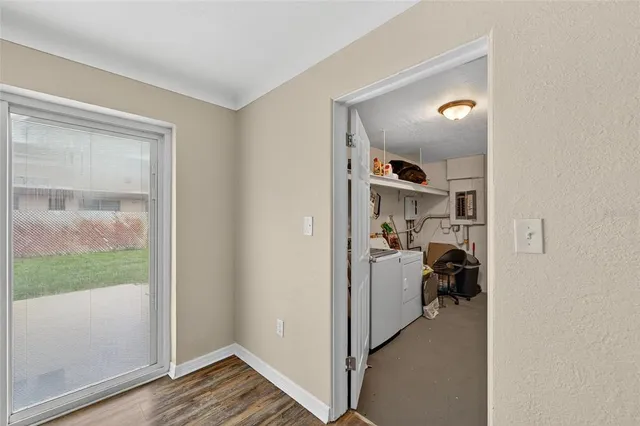 a view of an empty room with wooden floor
