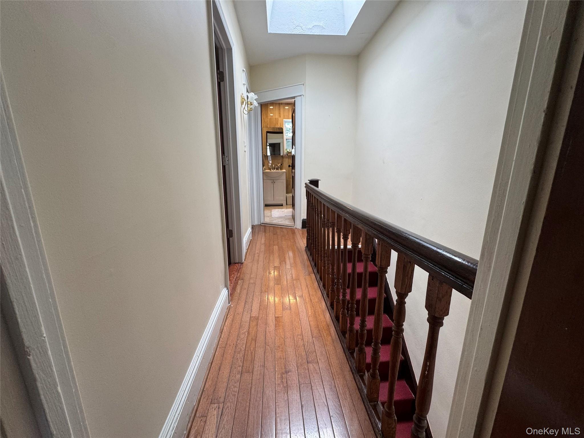 80-58 88th Road Queens, NY 11421 - Photo 18 of 21 a view of a hallway with wooden floor and stairs