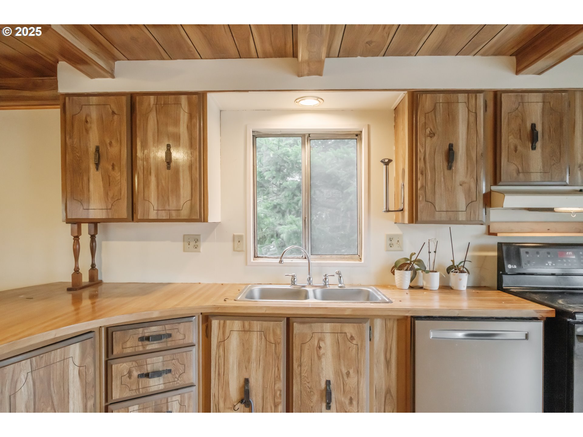 3760 Highway 101, Unit 7A Florence, OR 97439 - Photo 14 of 34 a kitchen with a sink a cabinets and window