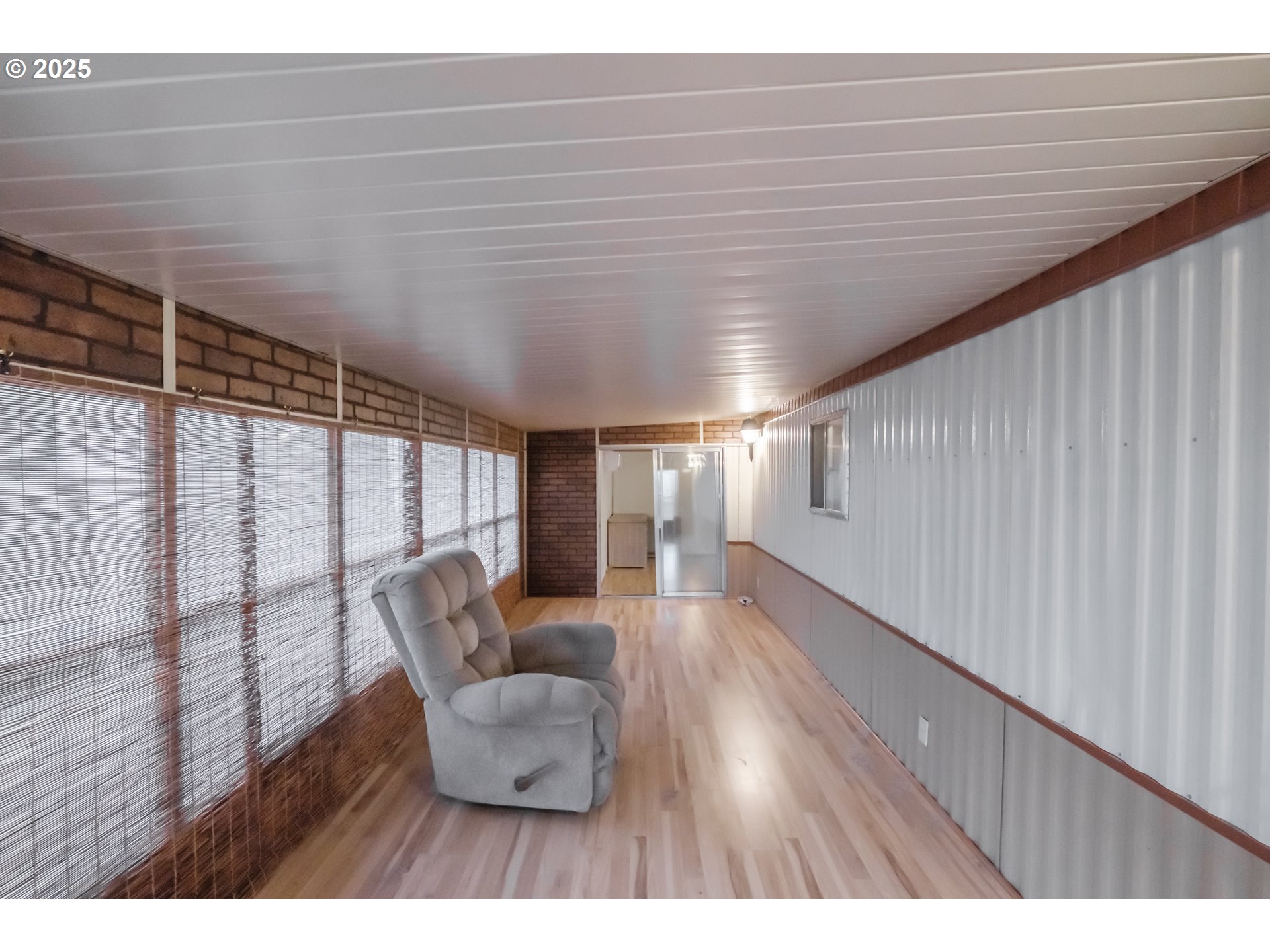 3760 Highway 101, Unit 7A Florence, OR 97439 - Photo 18 of 34 a hallway with wooden floor and furniture