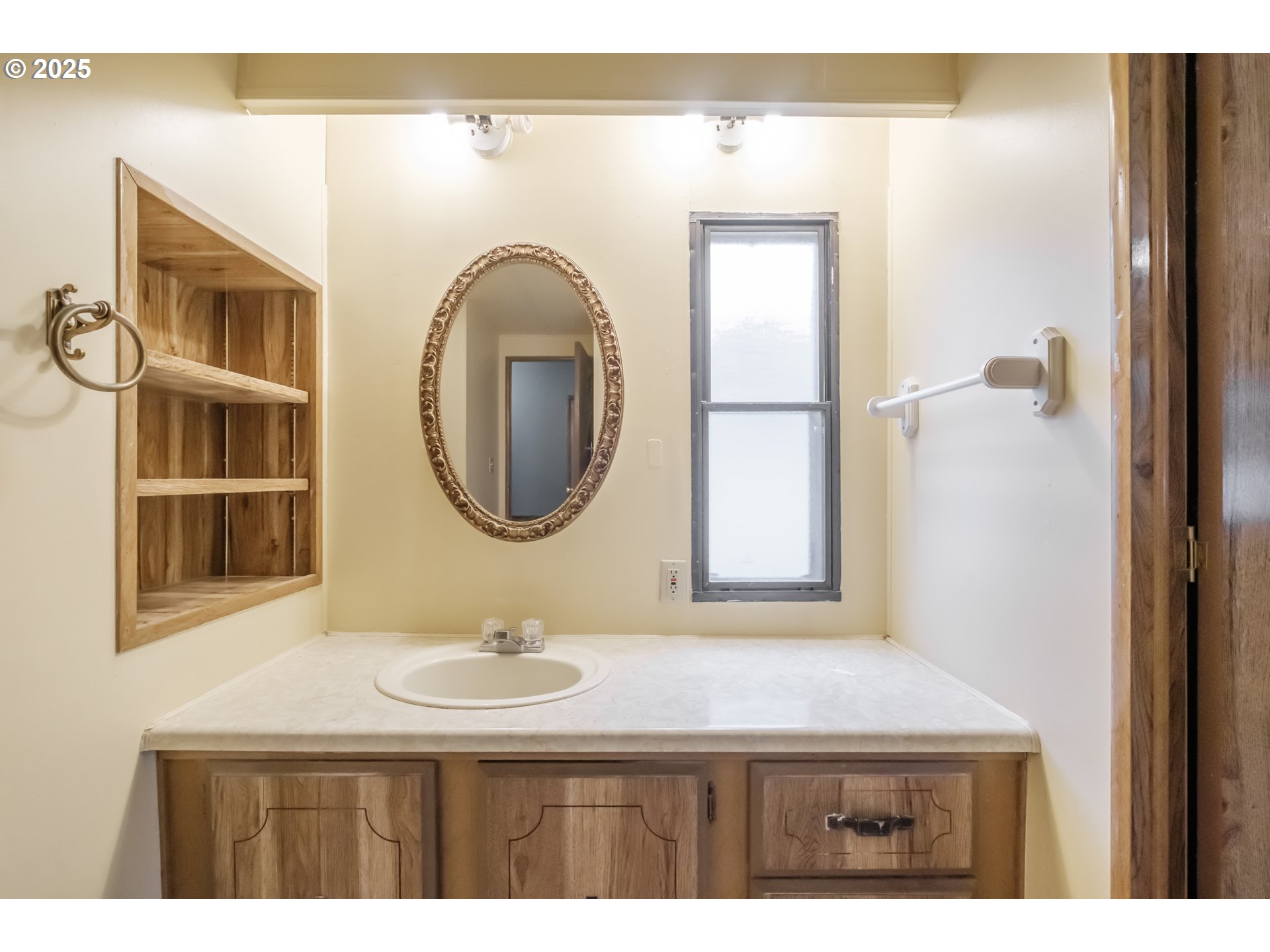 3760 Highway 101, Unit 7A Florence, OR 97439 - Photo 22 of 34 a bathroom with a sink a mirror a vanity and a window