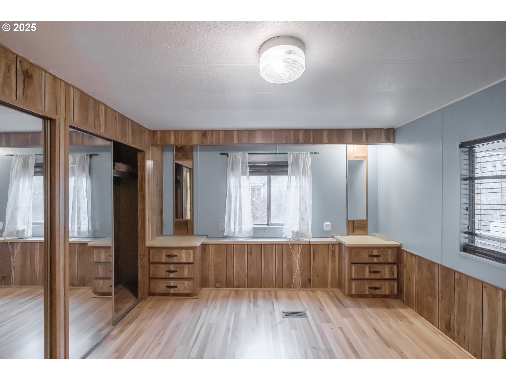 3760 Highway 101, Unit 7A Florence, OR 97439 - Photo 24 of 34 a room with wooden floors and windows