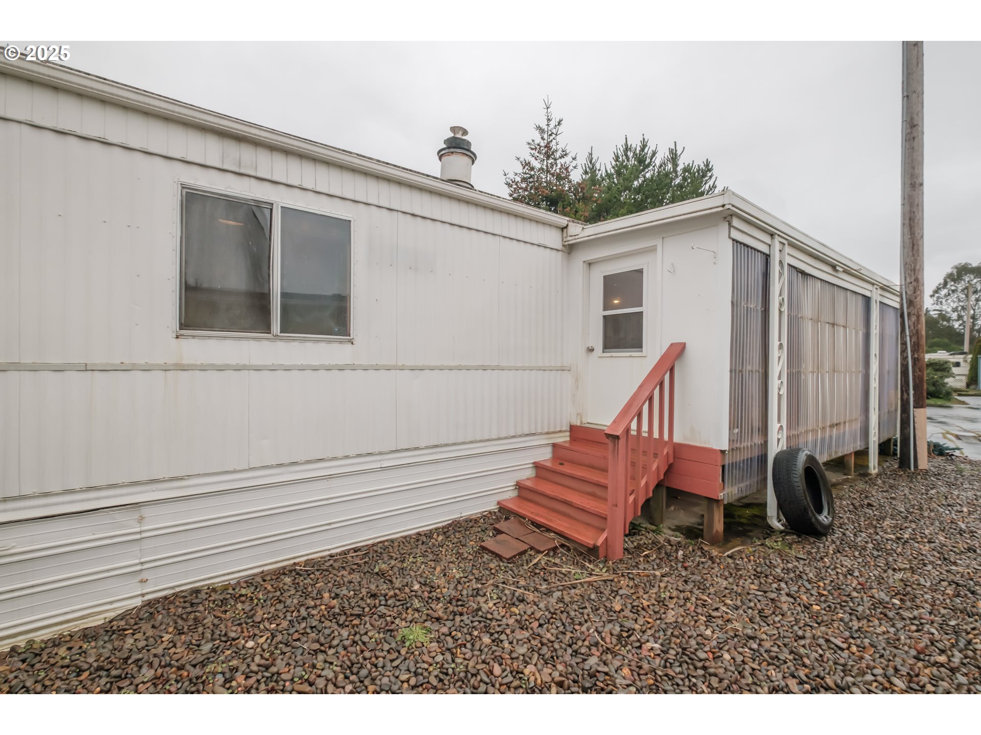 3760 Highway 101, Unit 7A Florence, OR 97439 - Photo 3 of 34 a view of a backyard with chairs and a fire pit