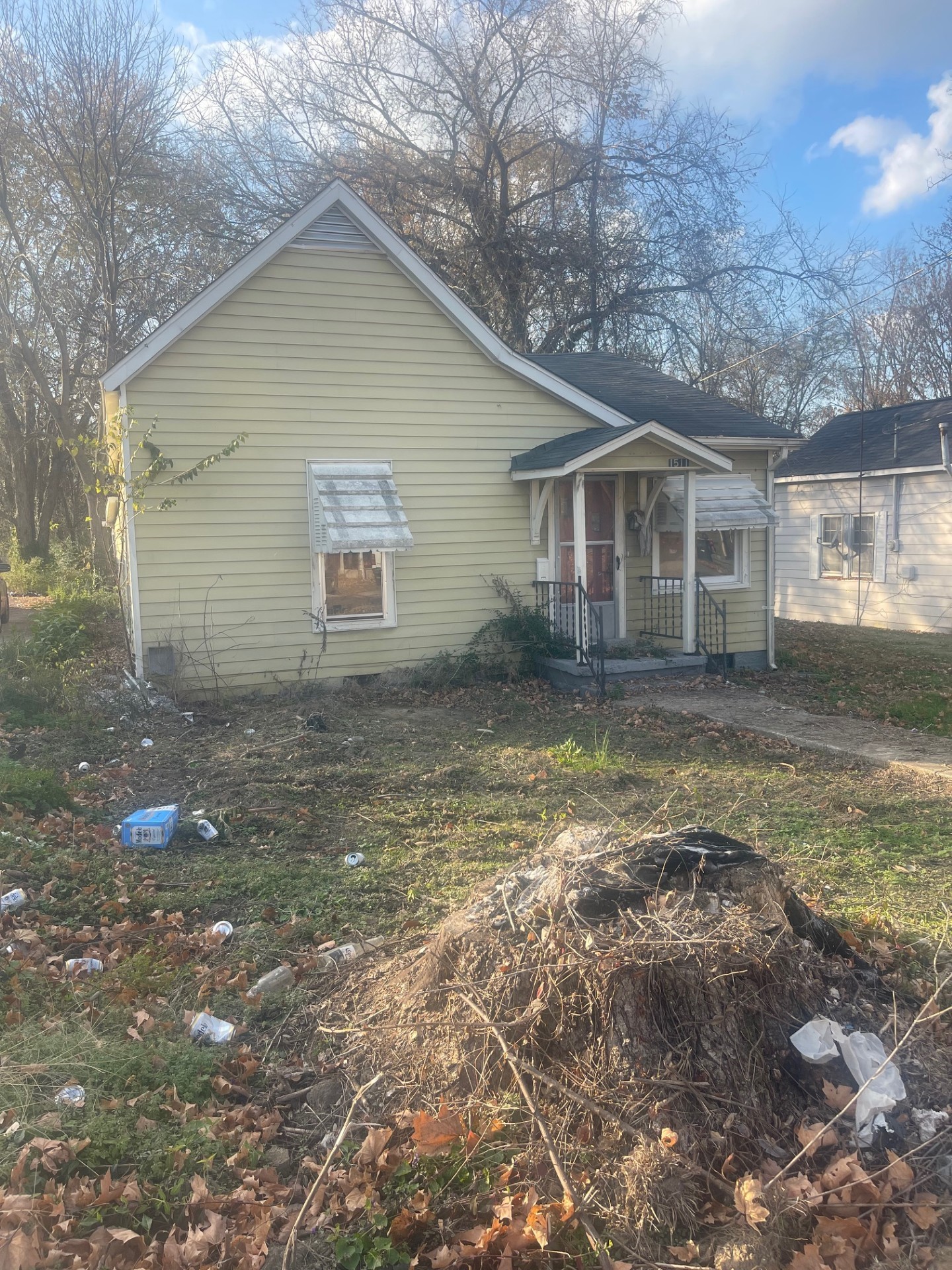 a view of a yard in front of a house with large windows
